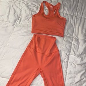 2 TSL workout sets. One is pants and the other is a shorts set.